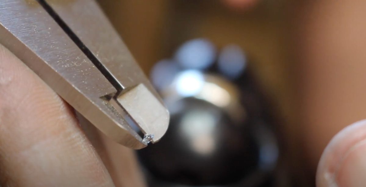 Measuring the gemstone with calipers to choose the right drill and burrs