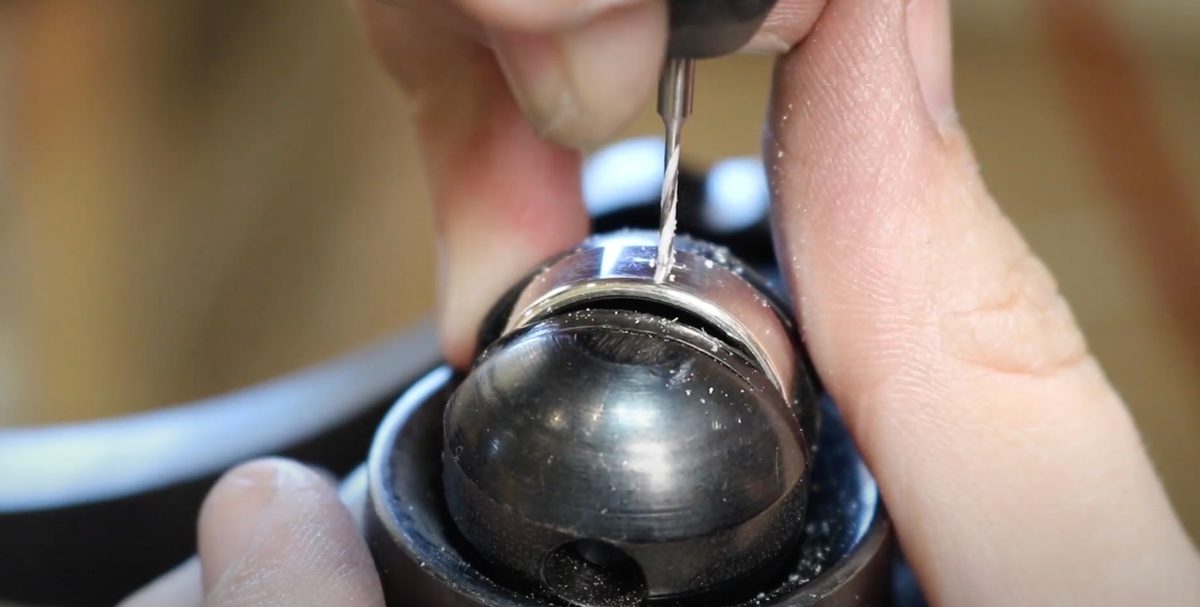 Drilling through the piece held in a clamp