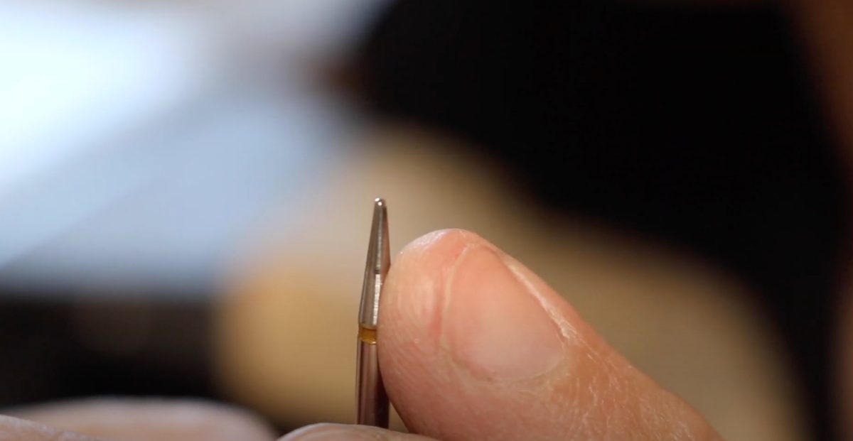 A home-made burnisher with a tapered, polished tip and a cork handle