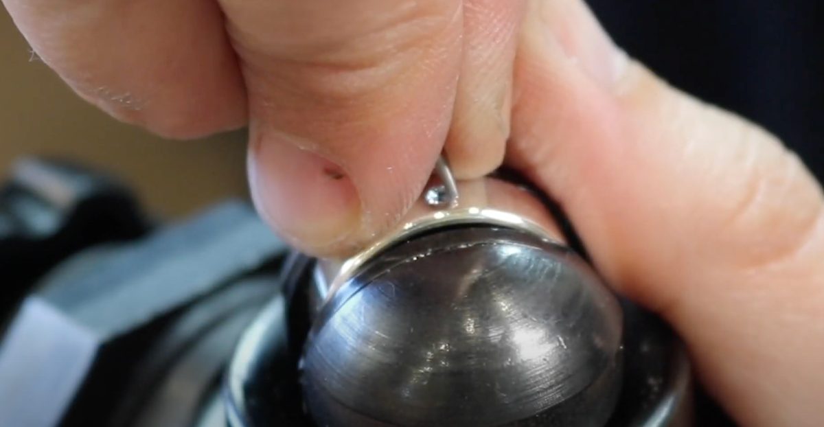 Burnishing the metal around the stone in a circular motion